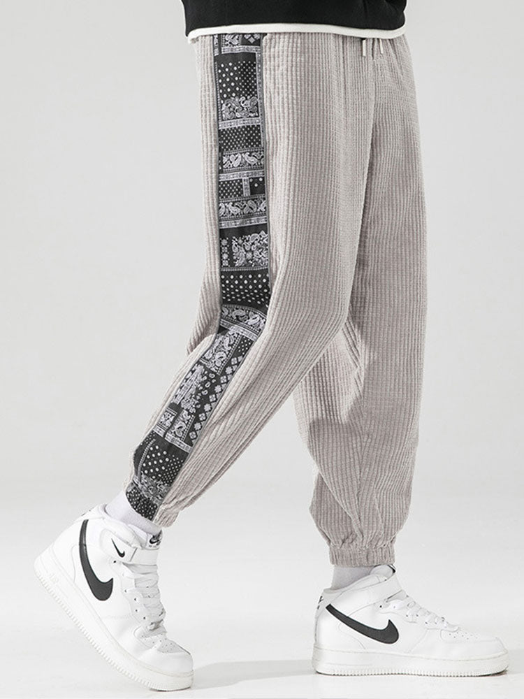 Calça de veludo cotelê com painéis estampados de paisley
