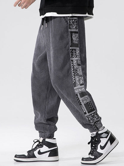 Calça de veludo cotelê com painéis estampados de paisley