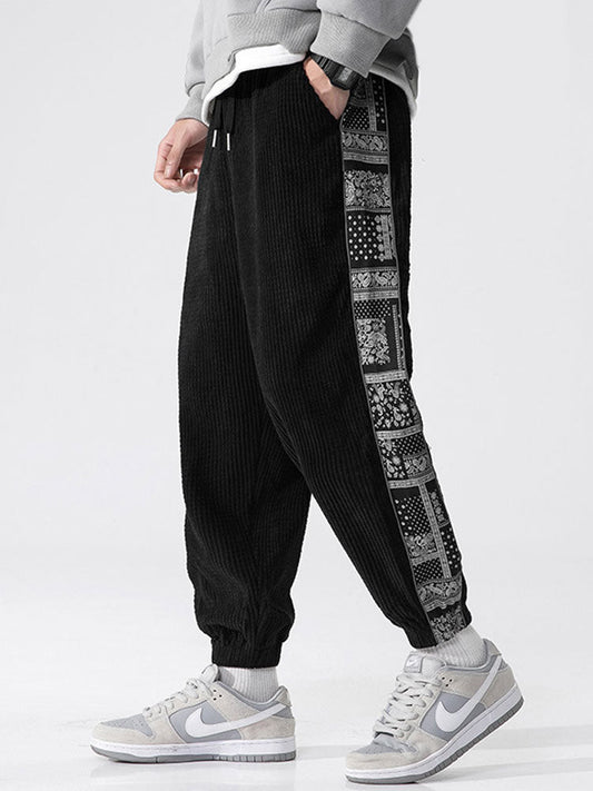 Calça de veludo cotelê com painéis estampados de paisley