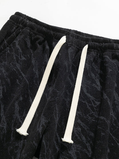 Calça de veludo cotelê com estampa marmorizada e perna reta