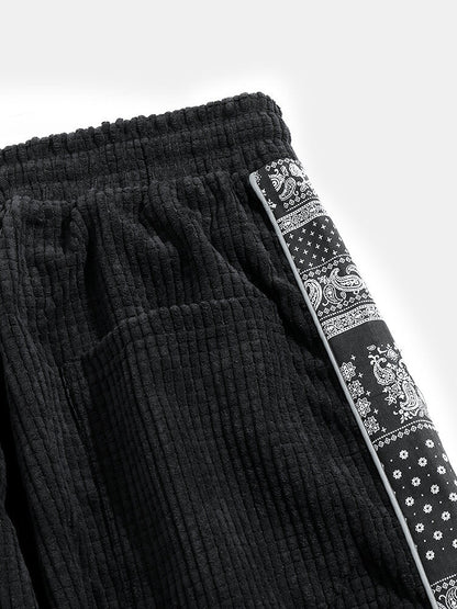 Calça de veludo cotelê com painéis estampados de paisley