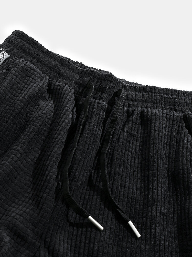 Calça de veludo cotelê com painéis estampados de paisley